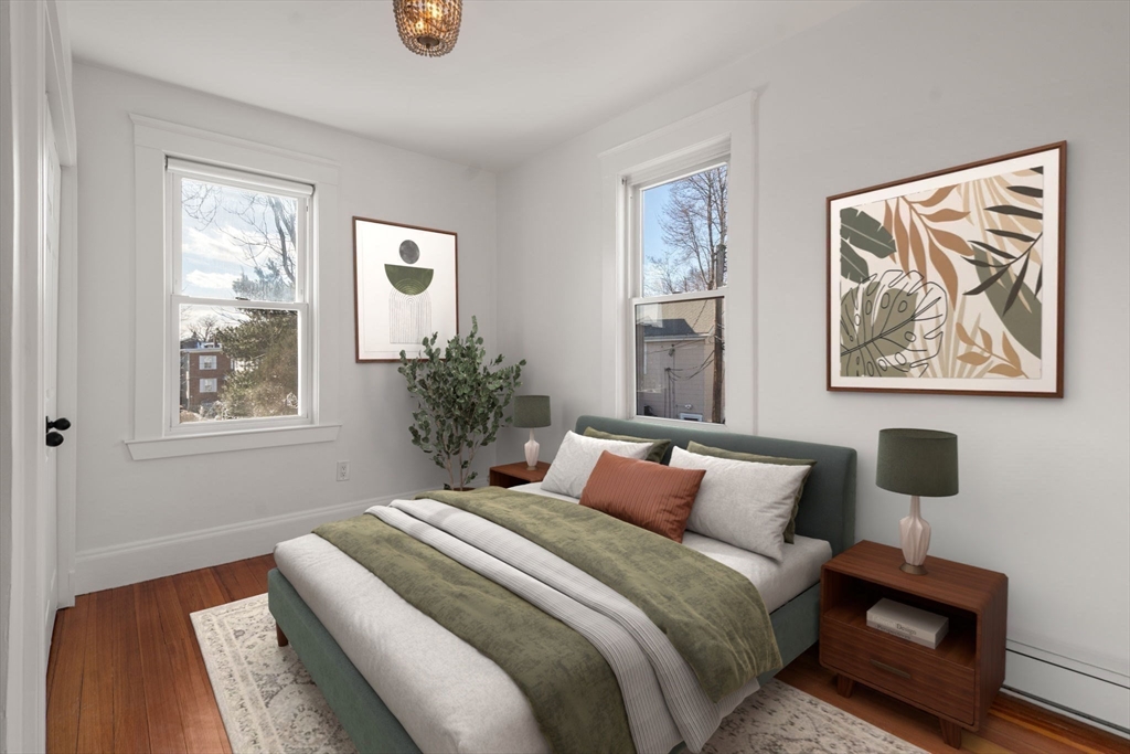 215 Ash Street, Unit 3 Waltham, MA 02453 - Photo 4 of 18 a bedroom with a bed and a painting on the wall