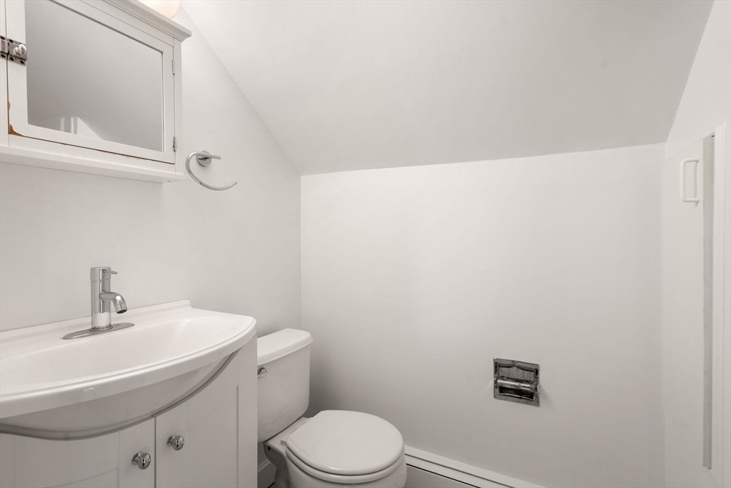 215 Ash Street, Unit 3 Waltham, MA 02453 - Photo 9 of 18 a bathroom with a sink a toilet and vanity