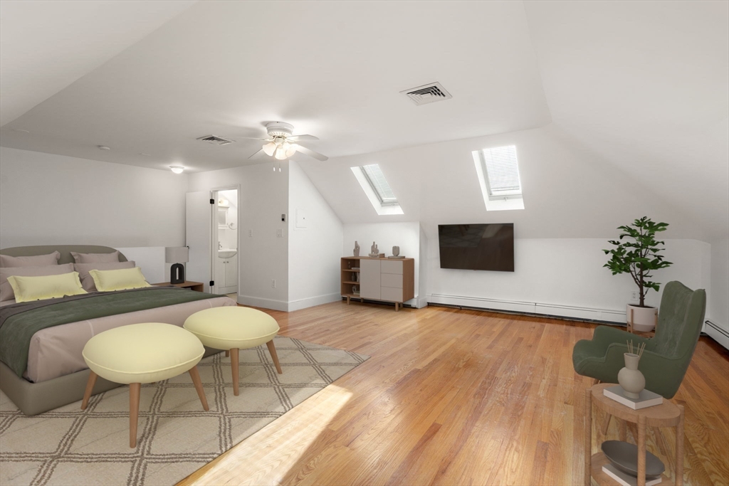 215 Ash Street, Unit 3 Waltham, MA 02453 - Photo 10 of 18 a living room with furniture a flat screen tv and a fireplace