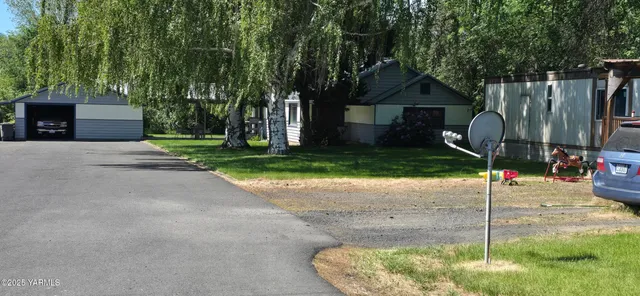 a backyard of a house with table and chairs