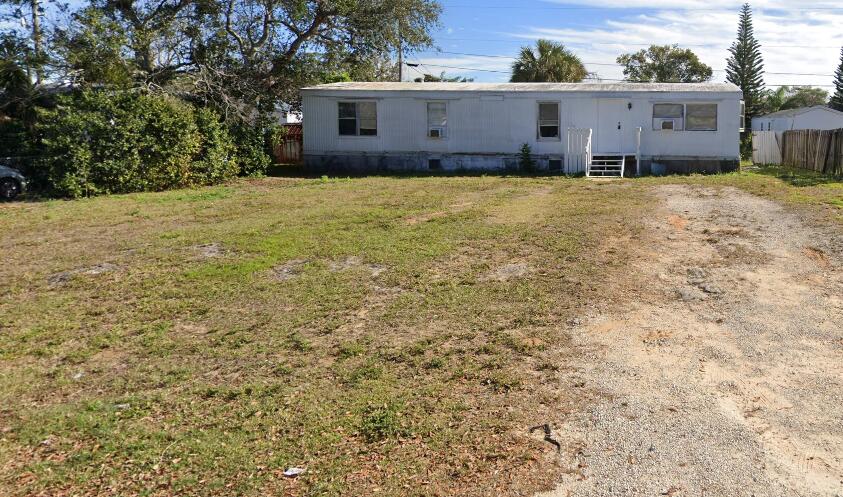 7002 Ash Drive Cocoa, FL 32927 - Photo 1 of 18 a view of a house with a yard