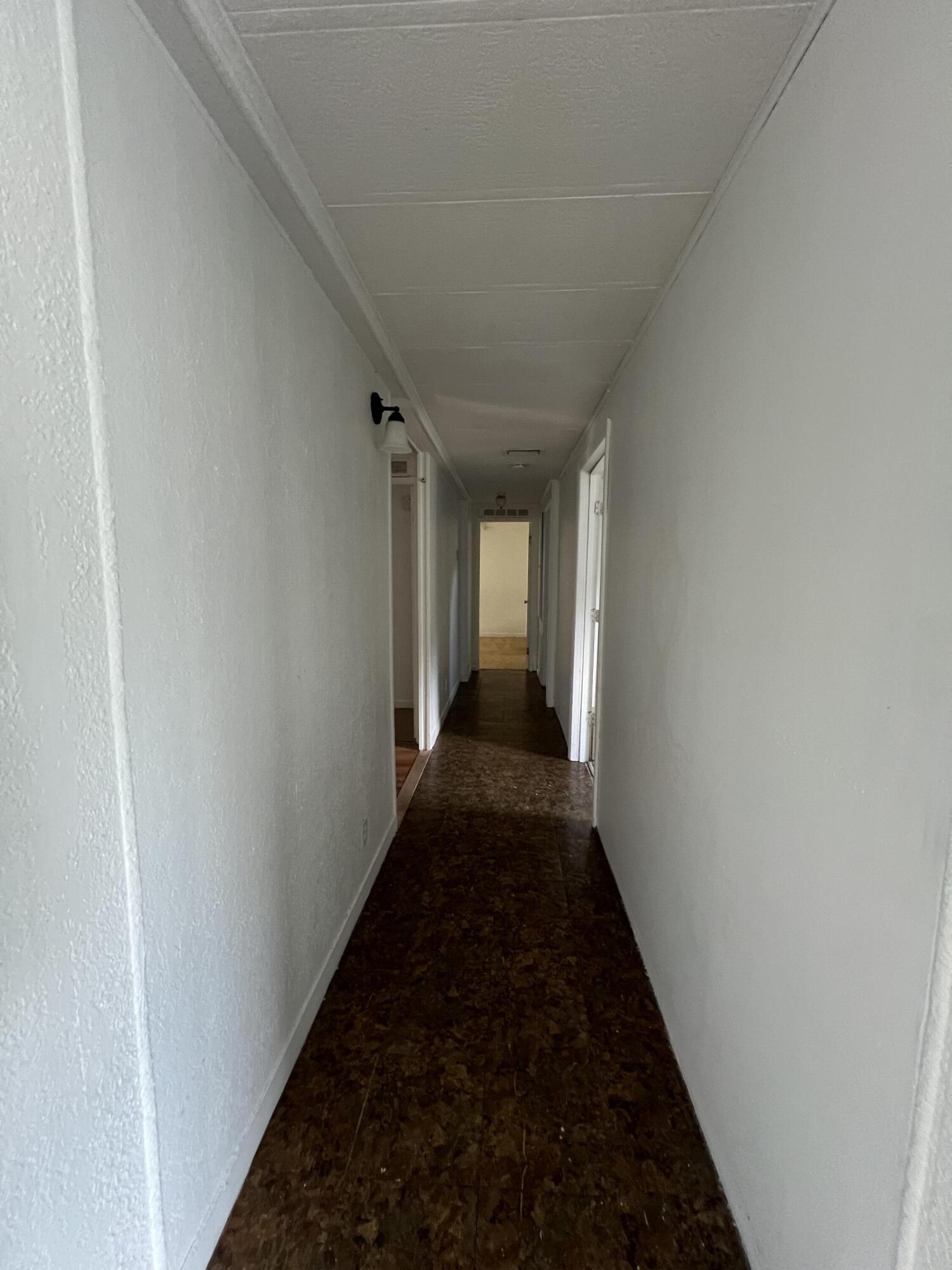 7002 Ash Drive Cocoa, FL 32927 - Photo 16 of 18 a view of a hallway with a flower pot