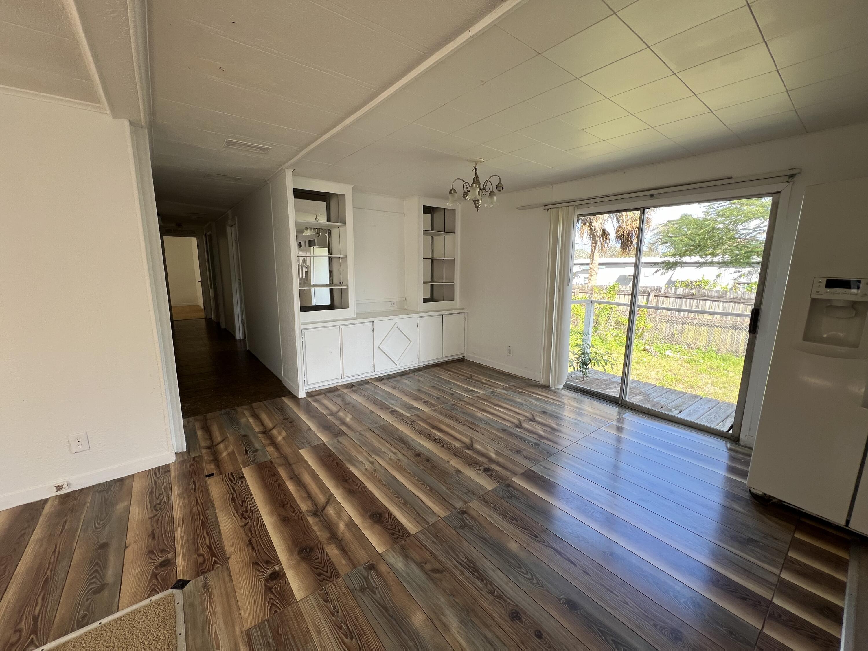 7002 Ash Drive Cocoa, FL 32927 - Photo 3 of 18 a view of an empty room with wooden floor and a window