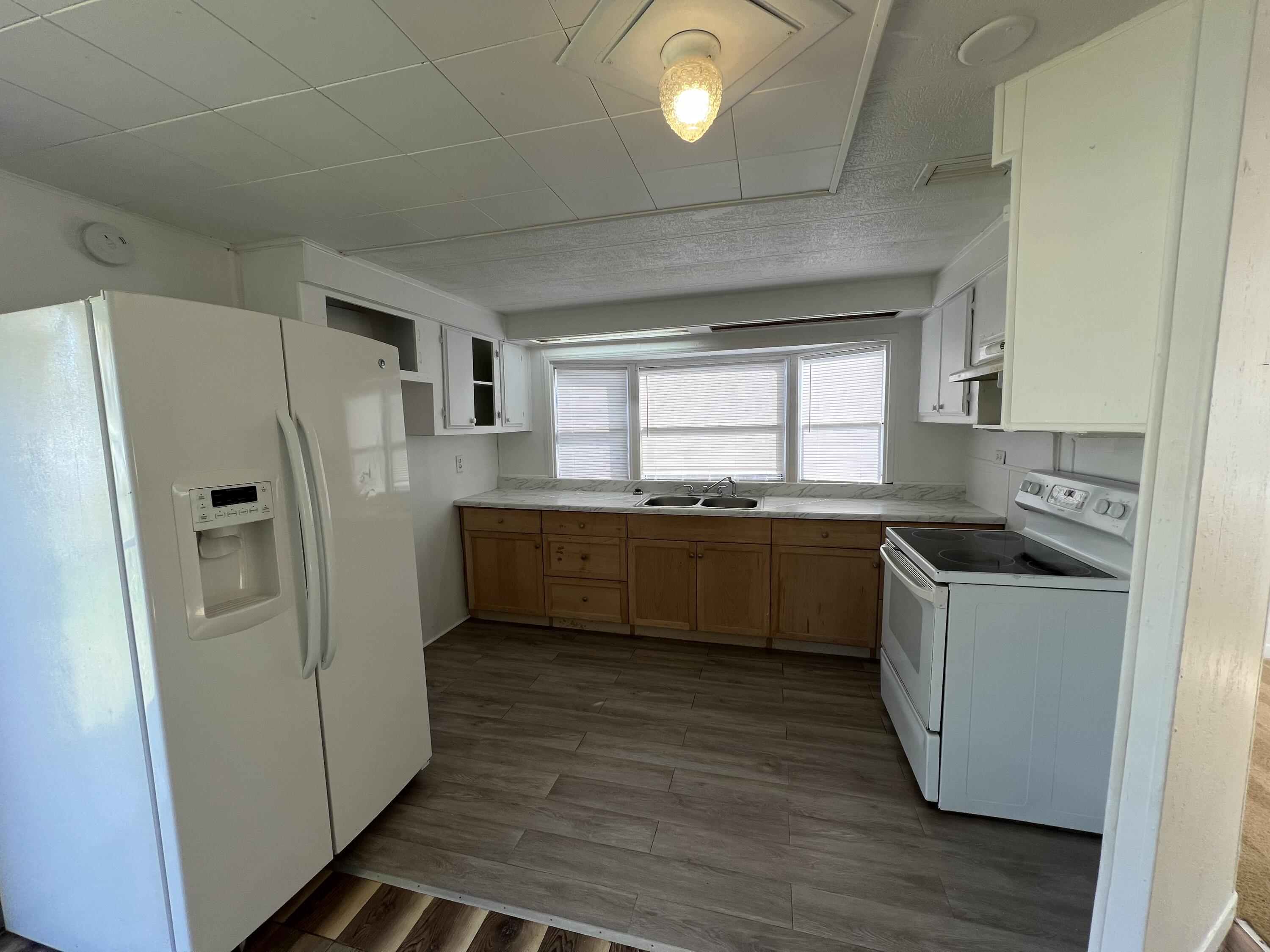 7002 Ash Drive Cocoa, FL 32927 - Photo 4 of 18 a kitchen with a refrigerator a sink and a stove