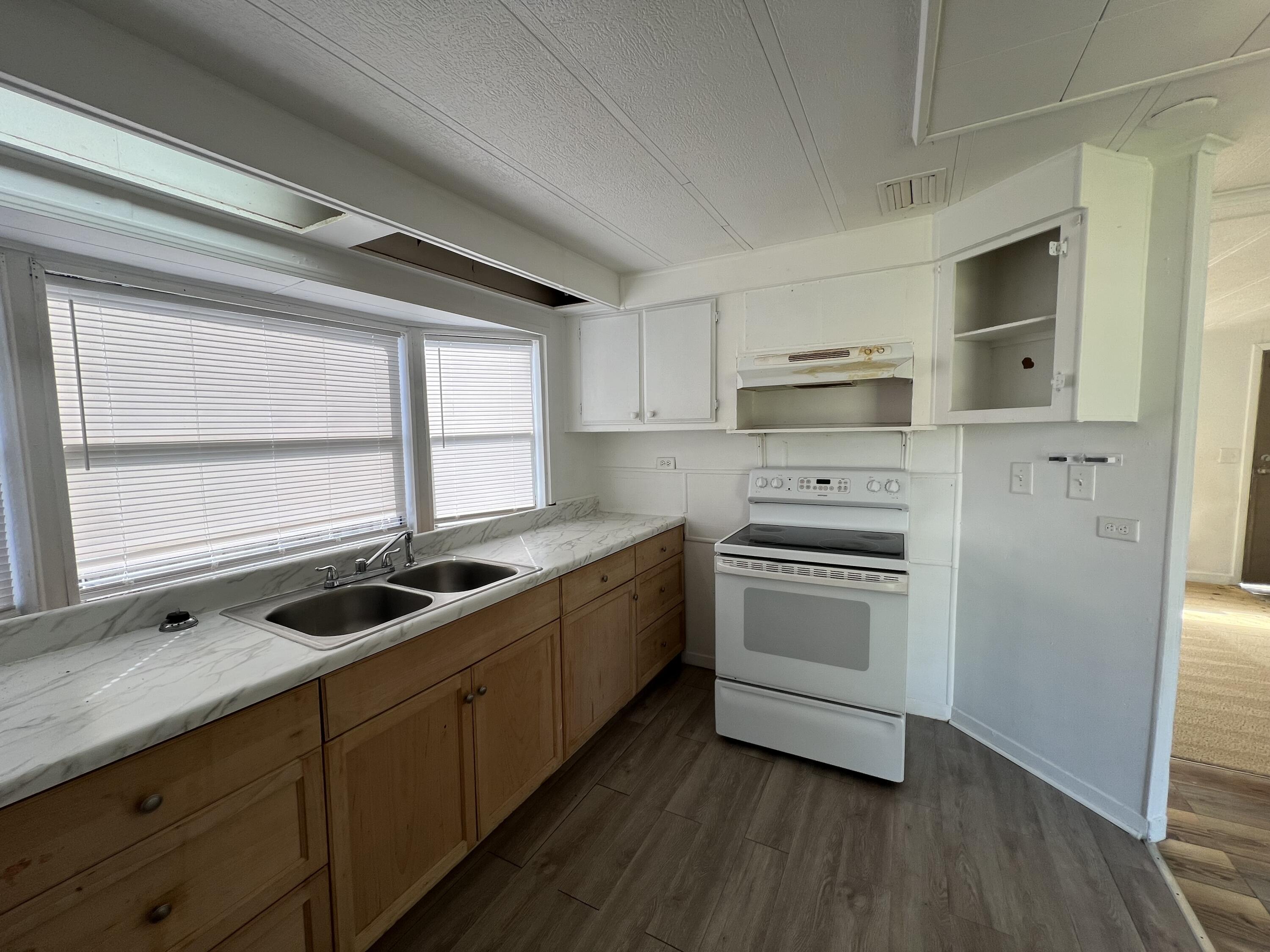 7002 Ash Drive Cocoa, FL 32927 - Photo 5 of 18 a kitchen with a stove a sink and a microwave