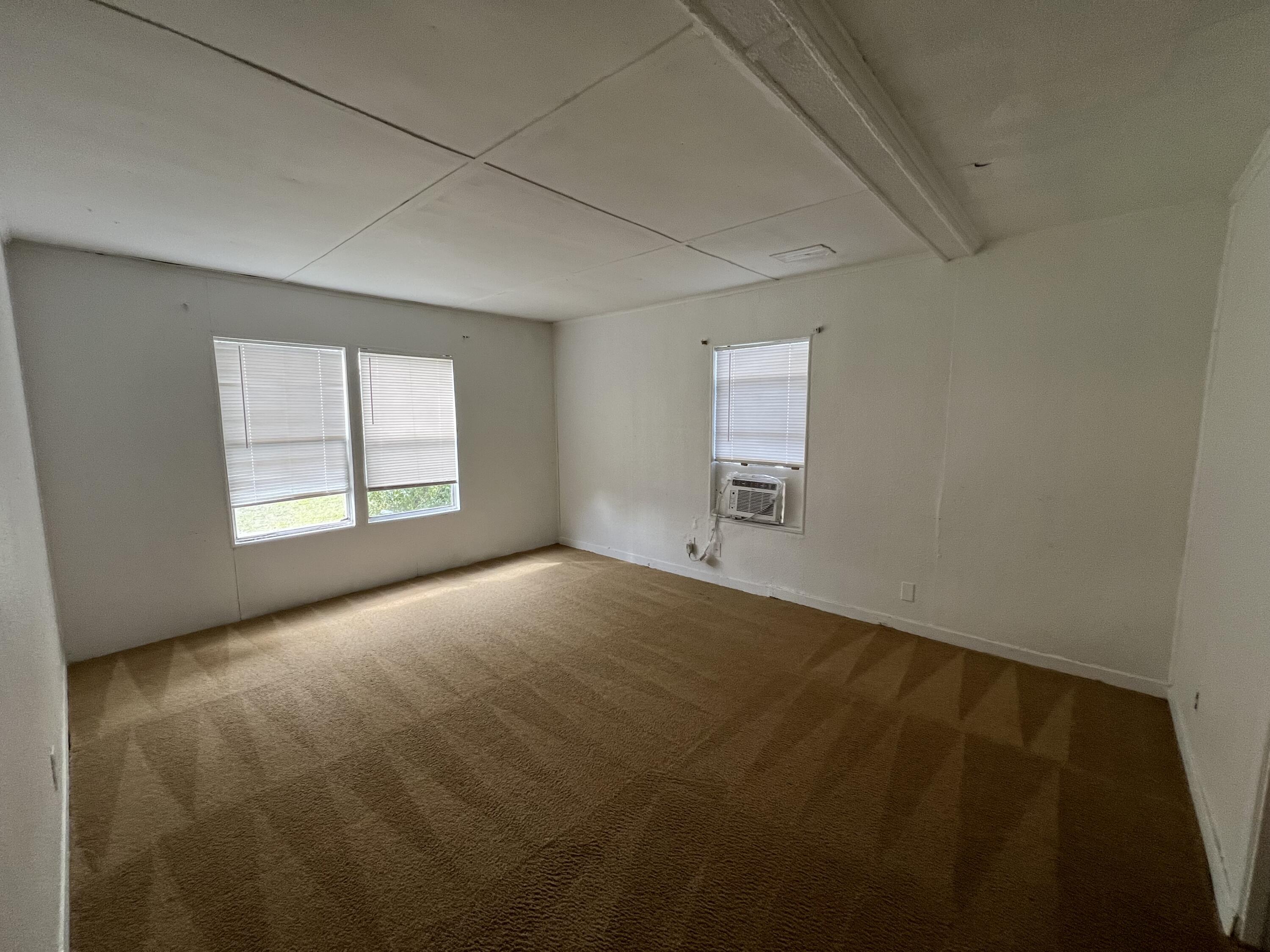 7002 Ash Drive Cocoa, FL 32927 - Photo 8 of 18 an empty room with a empty space and windows