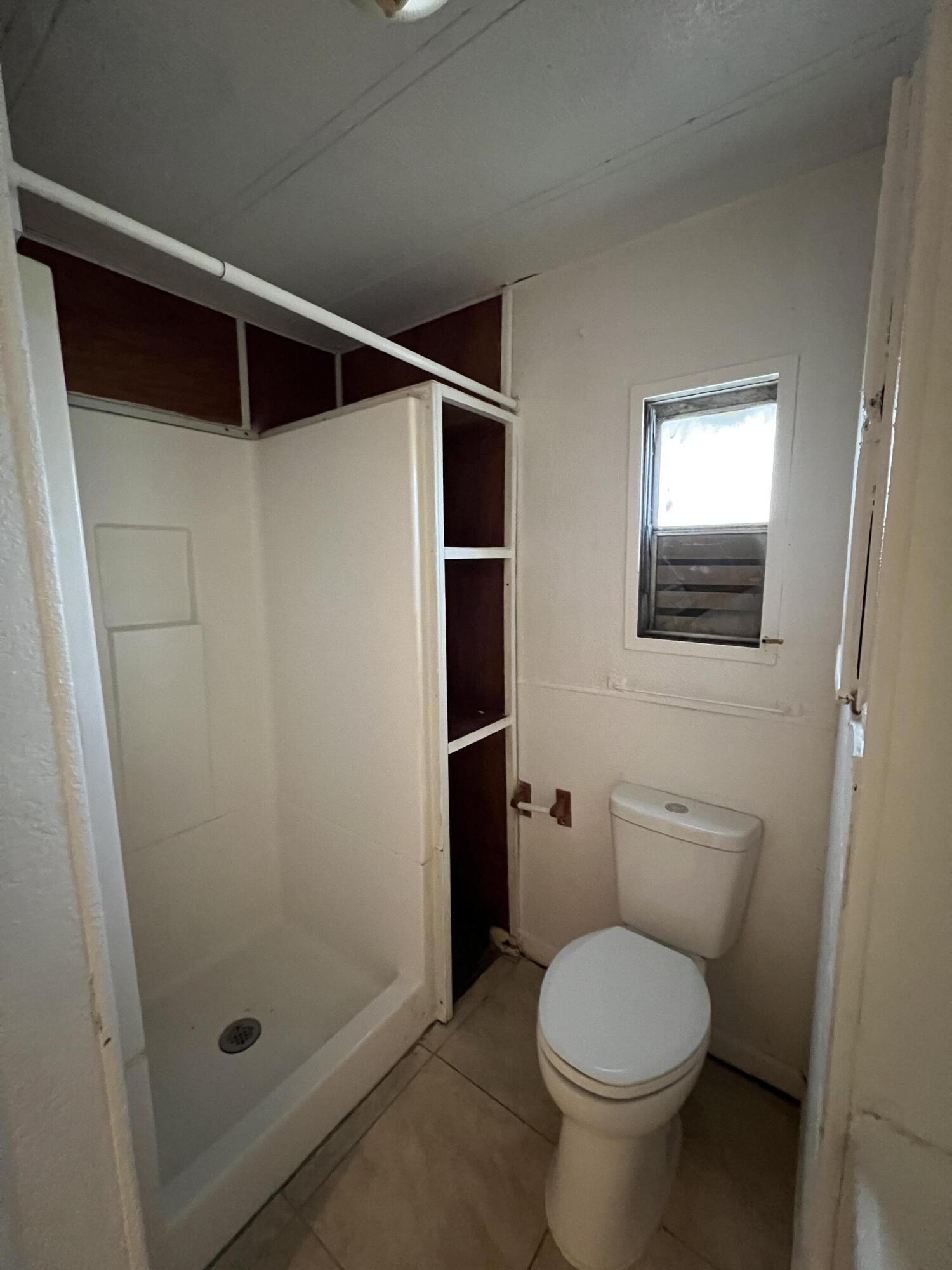 7002 Ash Drive Cocoa, FL 32927 - Photo 10 of 18 a bathroom with a toilet and a shower