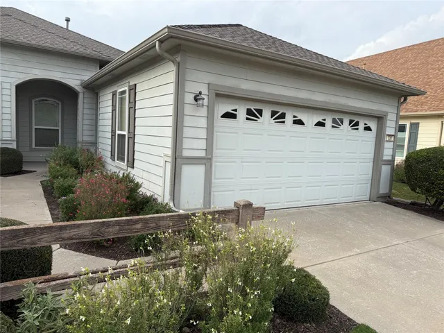 a front view of a house with garage