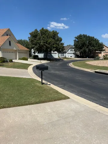 a view of a house with a yard and a street