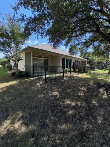 a view of a house with a tree in a yard