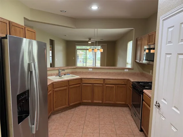 a kitchen with a sink stove and refrigerator