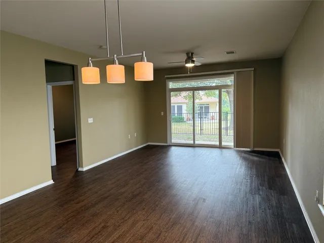 a view of a room with wooden floor and exposed radiator