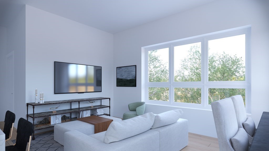 301 Border Street, Unit 305 Boston, MA 02128 - Photo 4 of 13 a living room with furniture and a flat screen tv