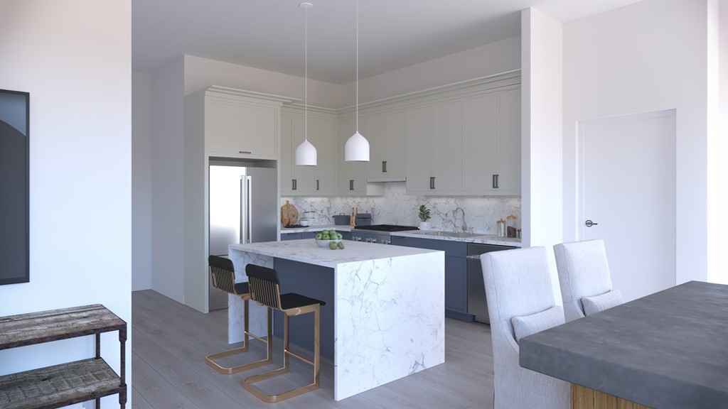 301 Border Street, Unit 305 Boston, MA 02128 - Photo 8 of 13 a kitchen with kitchen island a sink table and chairs