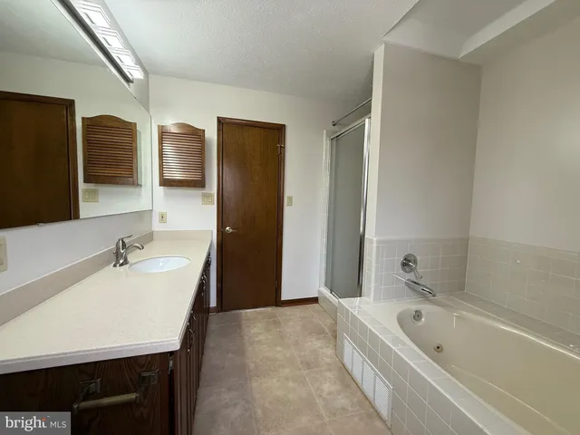 a bathroom with a bathtub and a sink