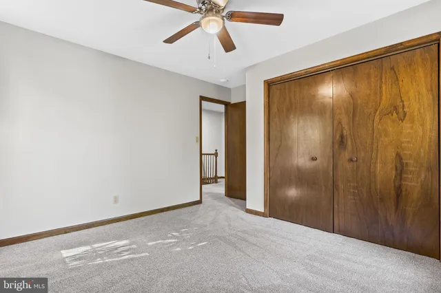 a view of a hallway with a chandelier fan