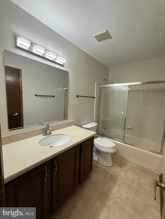 a bathroom with a double vanity sink toilet and shower
