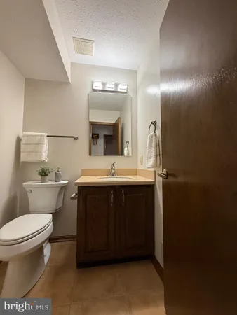 a bathroom with a sink toilet and mirror