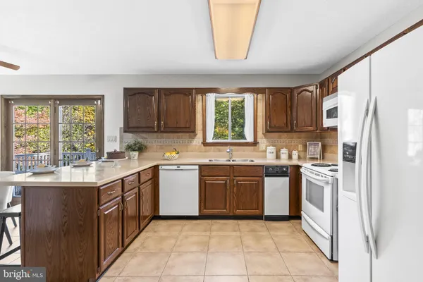 a kitchen with stainless steel appliances granite countertop a stove a sink dishwasher and a refrigerator