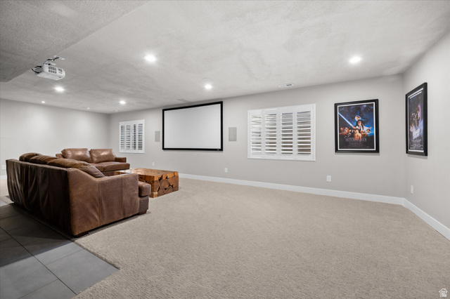 3359 Eurasian Crane Road Clinton, UT 84015 - Photo 41 of 71 Cinema with light colored carpet, a textured ceiling, recessed lighting, and light tile patterned floors