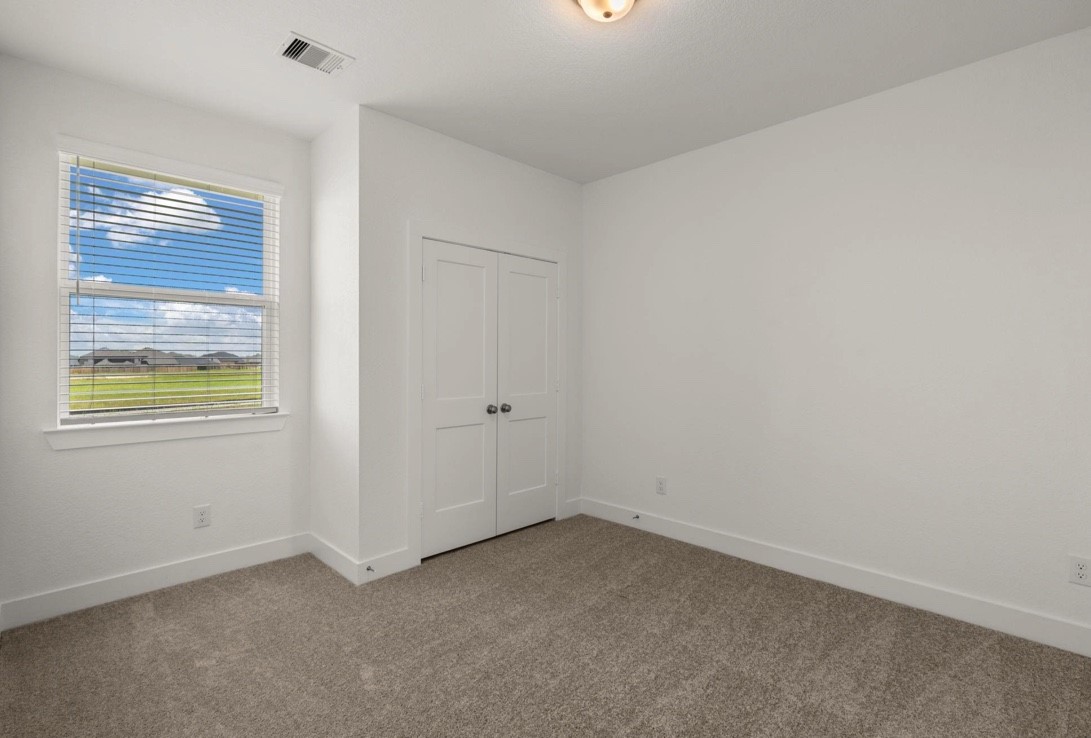 5234 Capricorn Way Manvel, TX 77578 - Photo 13 of 25 an empty room with windows