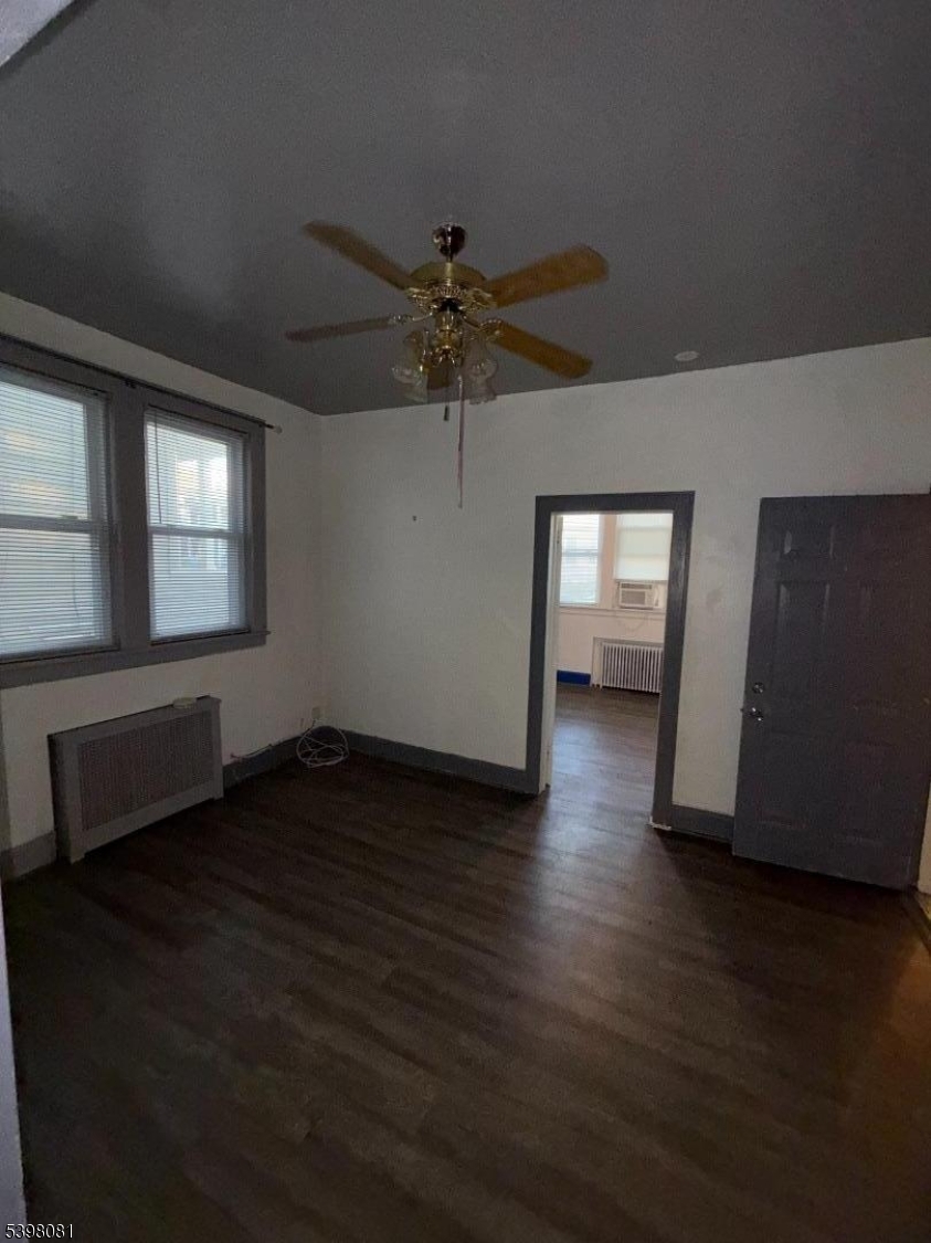 177 9th Street Passaic, NJ 07055 - Photo 3 of 6 wooden floor in an empty room with a window