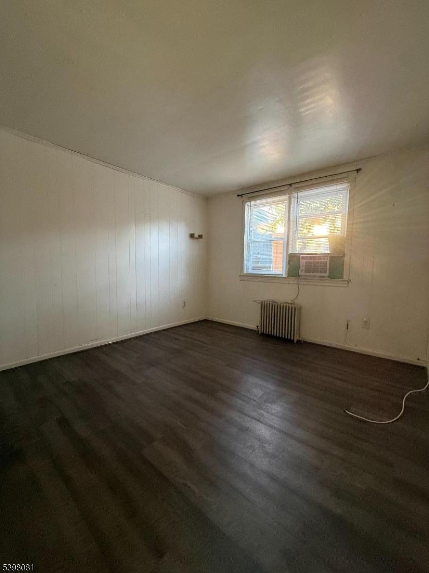 177 9th Street Passaic, NJ 07055 - Photo 4 of 6 an empty room with wooden floor and windows