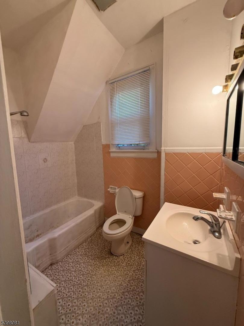 177 9th Street Passaic, NJ 07055 - Photo 6 of 6 a bathroom with a sink a toilet and shower