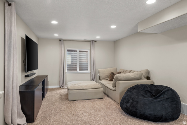 955 Delorean Lane Midvale, UT 84047 - Photo 35 of 47 Recessed lighting illuminates this carpeted room featuring a white-framed window with horizontal blinds and an integrated wall shelf