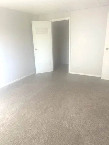 a view of an empty room and a window