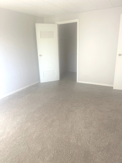 1102 Westover Lane, Unit 1C Schaumburg, IL 60193 - Photo 6 of 8 a view of an empty room and a window