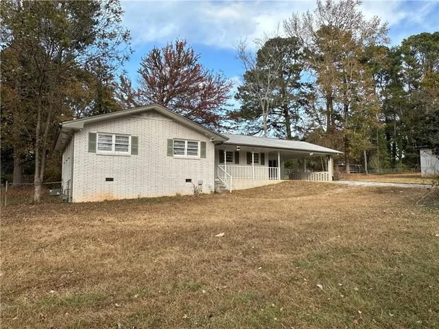 a front view of house with yard and trees