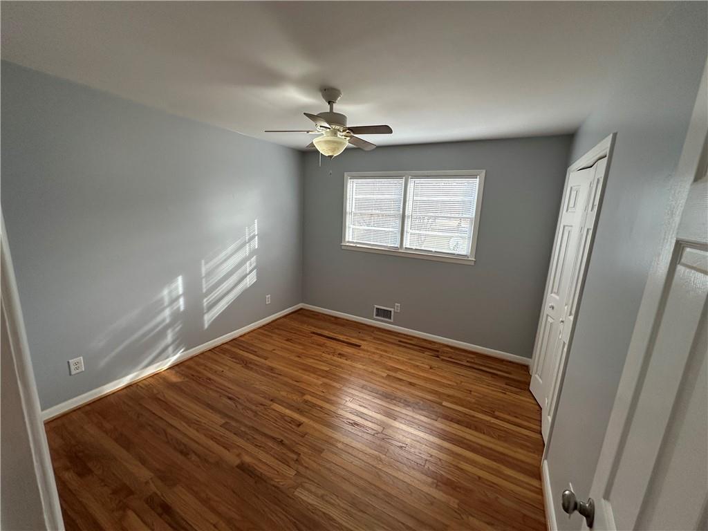 423 Center Circle Southwest Conyers, GA 30094 - Photo 15 of 24 a view of empty room with wooden floor and fan