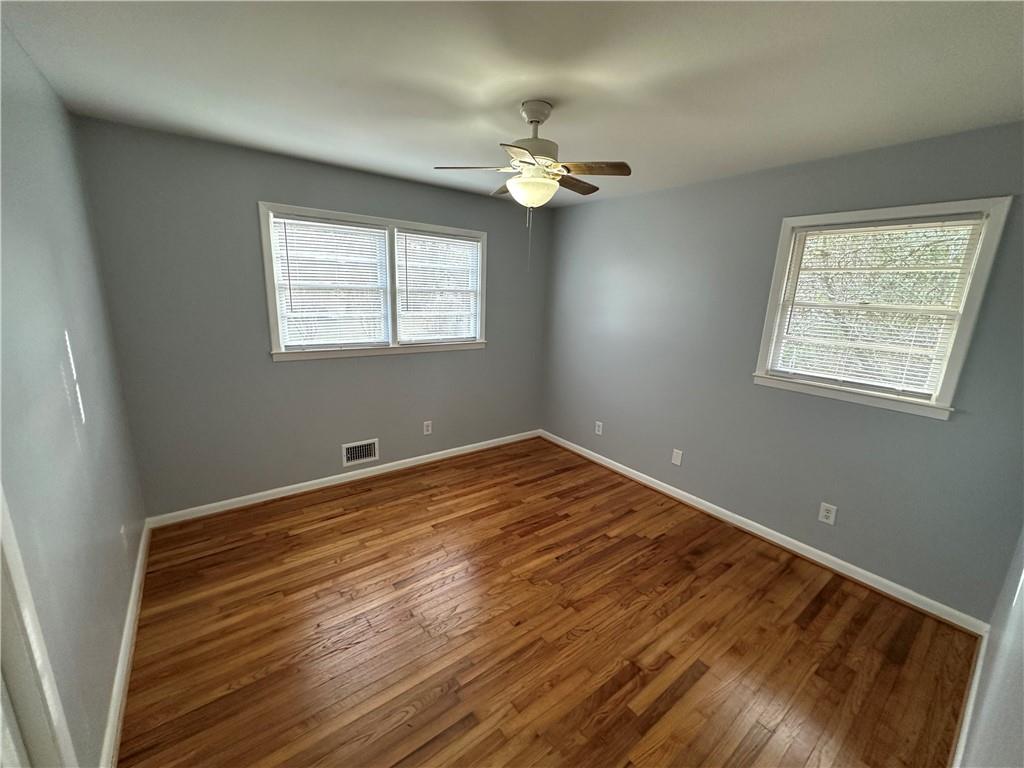 423 Center Circle Southwest Conyers, GA 30094 - Photo 16 of 24 wooden floor in an empty room with a window