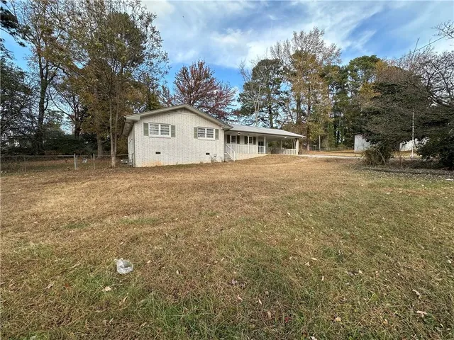a view of a house with a tree in front of it