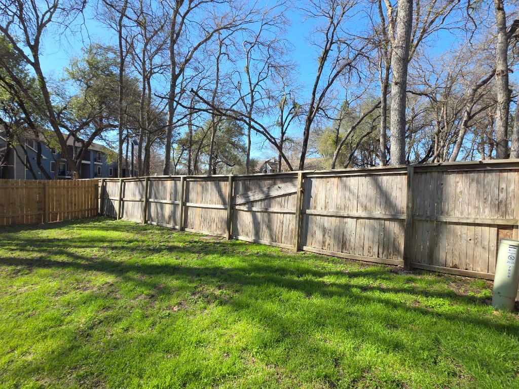 7809 Topawa Cove, Unit B Austin, TX 78729 - Photo 15 of 15 a yard with trees in the background
