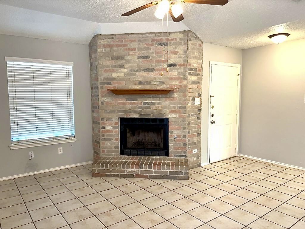7809 Topawa Cove, Unit B Austin, TX 78729 - Photo 3 of 15 a living room with a fireplace