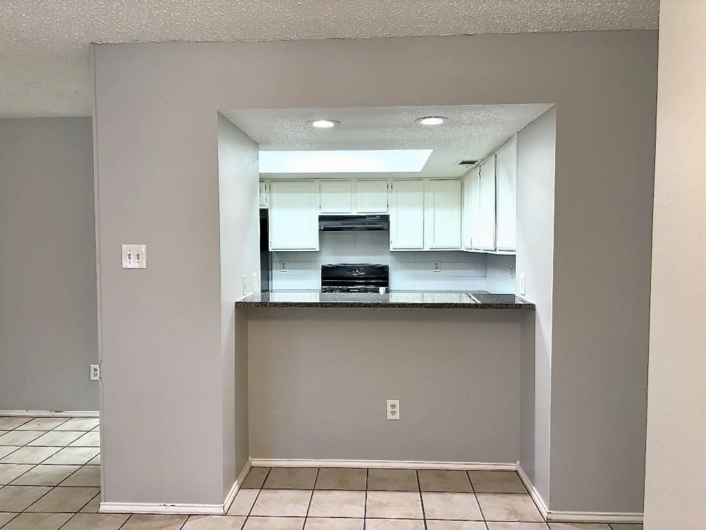 7809 Topawa Cove, Unit B Austin, TX 78729 - Photo 6 of 15 a kitchen with a sink and cabinets