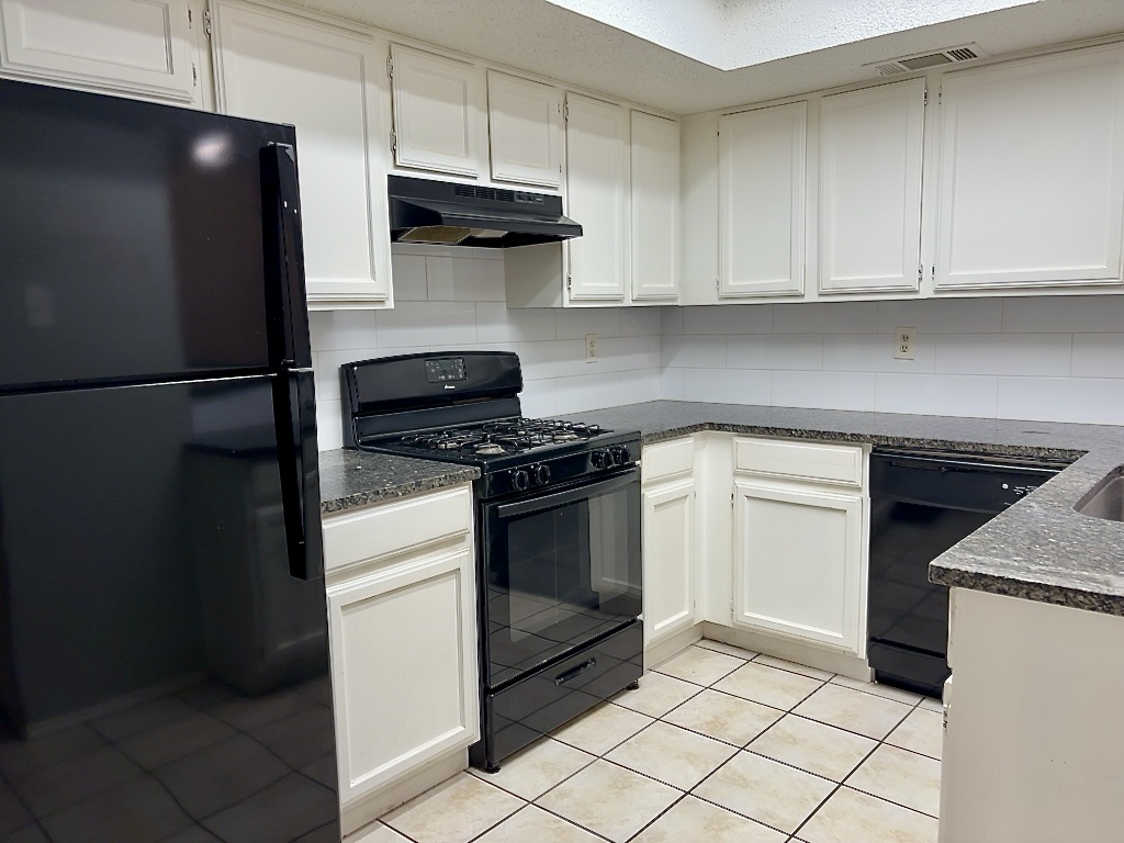 7809 Topawa Cove, Unit B Austin, TX 78729 - Photo 7 of 15 a kitchen with a stove and a refrigerator