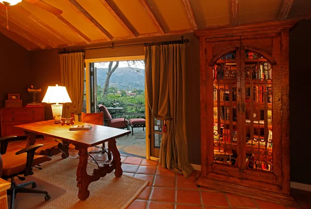 a view of a room with a table and chairs