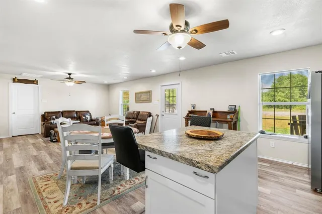 a kitchen with granite countertop cabinets and a table