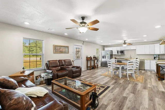 a living room with furniture and kitchen view
