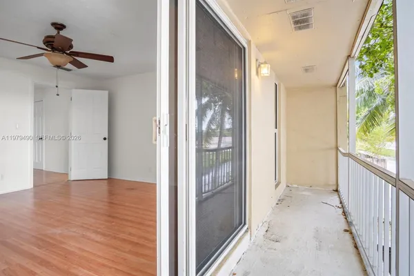 a view of a hallway view with wooden floor and windows