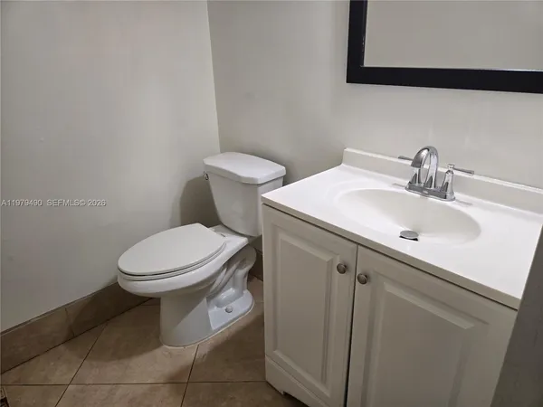 a white toilet sitting next to a bathroom sink