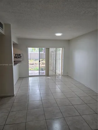 a view of an empty room and a window