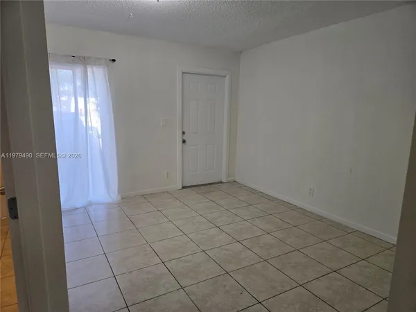 a view of an empty room and wooden floor