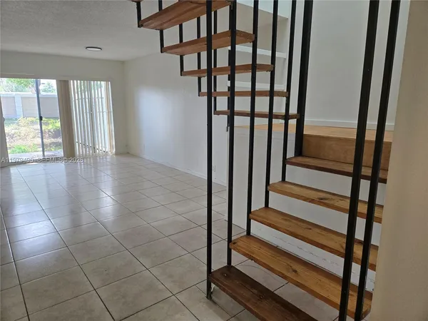 a view of staircase with white walls and a window