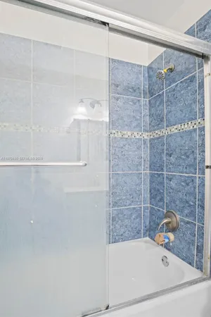 a bathroom with a bathtub and shower