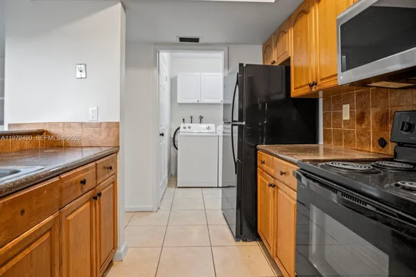 a kitchen with a stove cabinets and a refrigerator