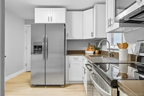 a kitchen with stainless steel appliances granite countertop a refrigerator and a sink